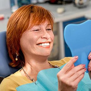 Woman smiling while looking in the mirror