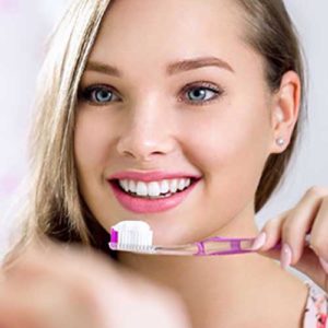 Young woman brushing her teeth